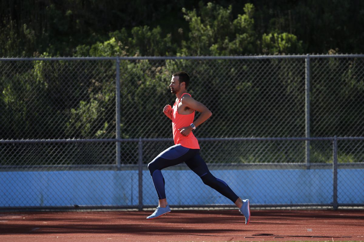 a male athlete runs on a track