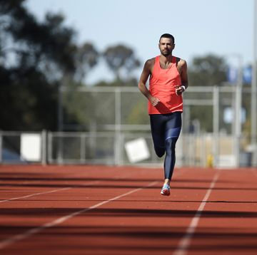 a male athlete runs on a track