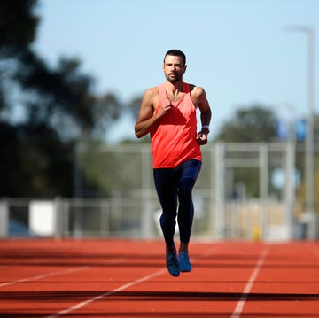 A male athlete runs on a track a male athlete runs on a track