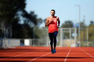 a male athlete runs on a track