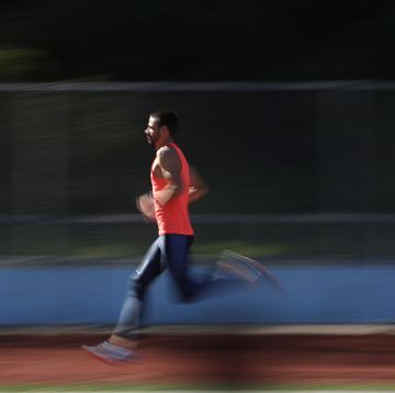 a male athlete runs on a track