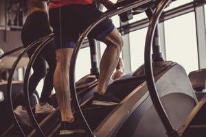 male athlete using stair climbing machine in the gym