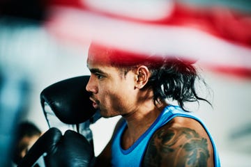 male boxer working out in ring in boxing gym