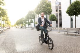 male commuter with electric bike in mitte