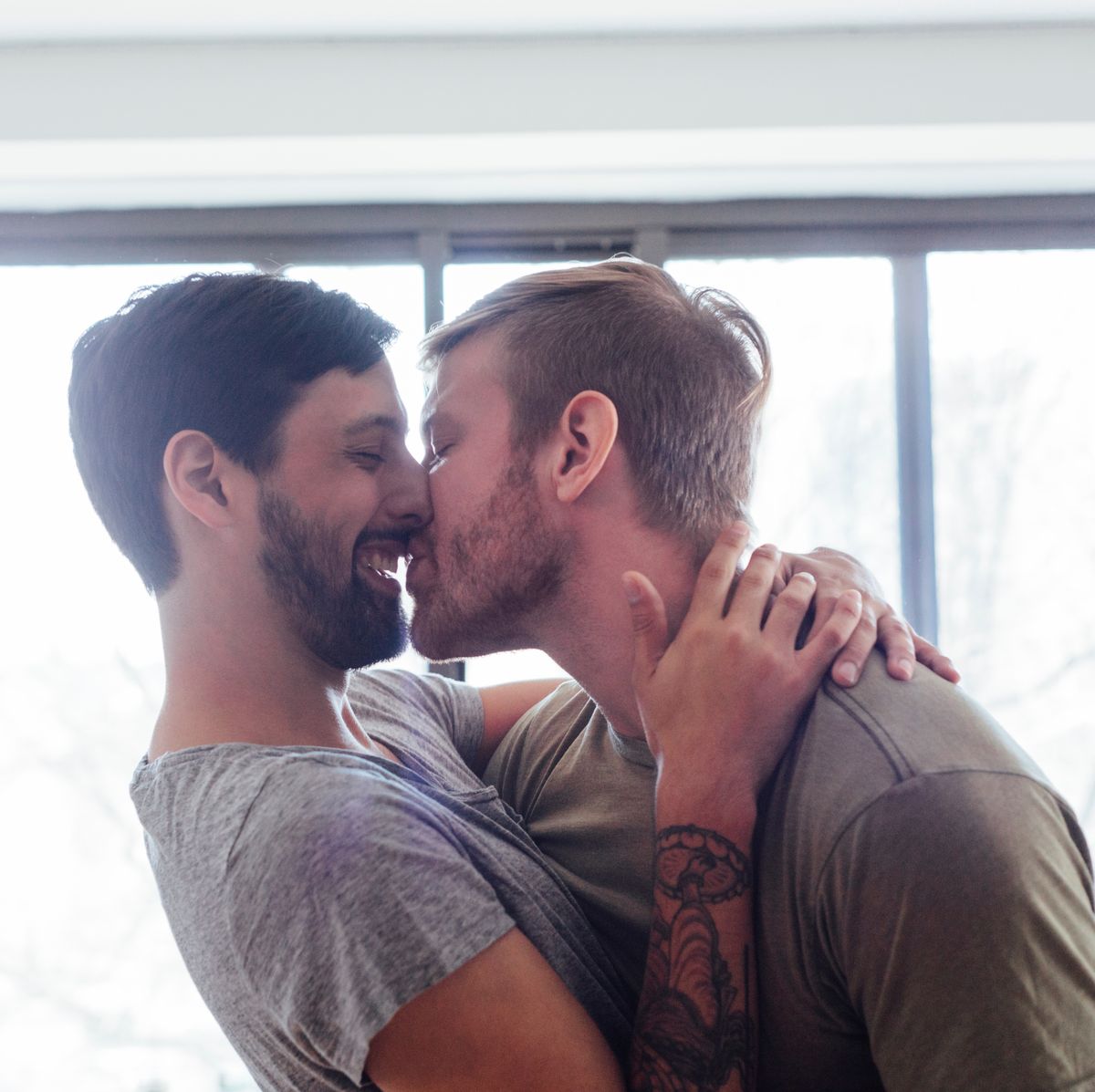 male couple at home fooling around kissing and royalty free image