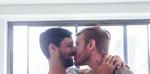 male couple at home fooling around kissing and royalty free image
