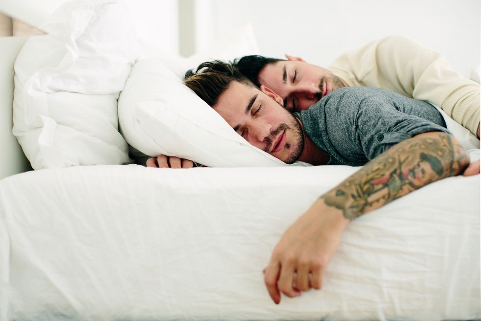 Male couple in bed, sleeping