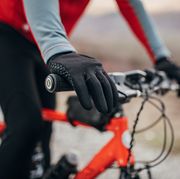 male cyclist riding bicycle on road, raynaud's syndrome