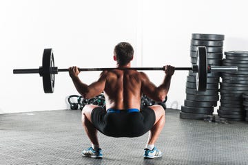 male doing weights during gym