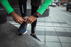 male jogger tying his shoe