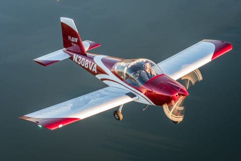 male pilot operating blue vans rv 12 light sport aircraft with female photographer flying over the chesapeake bay, stevensville, maryland