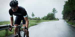 Male race cyclist driving up mountain road