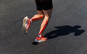 male runner legs on calf kinesio taping run marathon