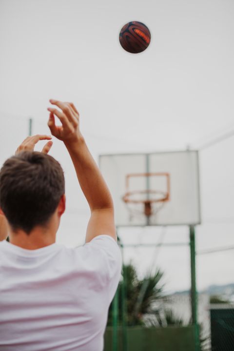 male teenager playing basketball