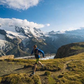 male trail runner ascends above glaciated landscape