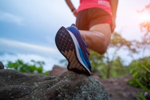 male trail runner running in the forest on a trial