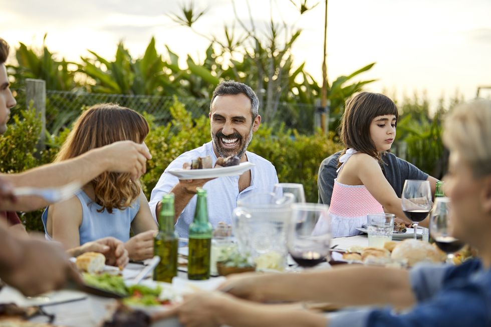 males and females celebrating asado in backyard