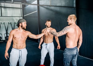 males fist bumping in cross training gym