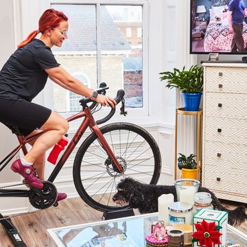 a person riding a bicycle on an indoor trainer