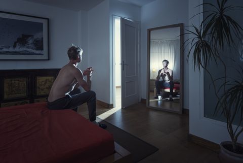 man alone in his bedroom