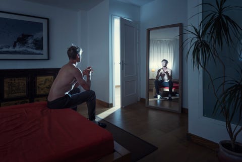 man alone in his bedroom