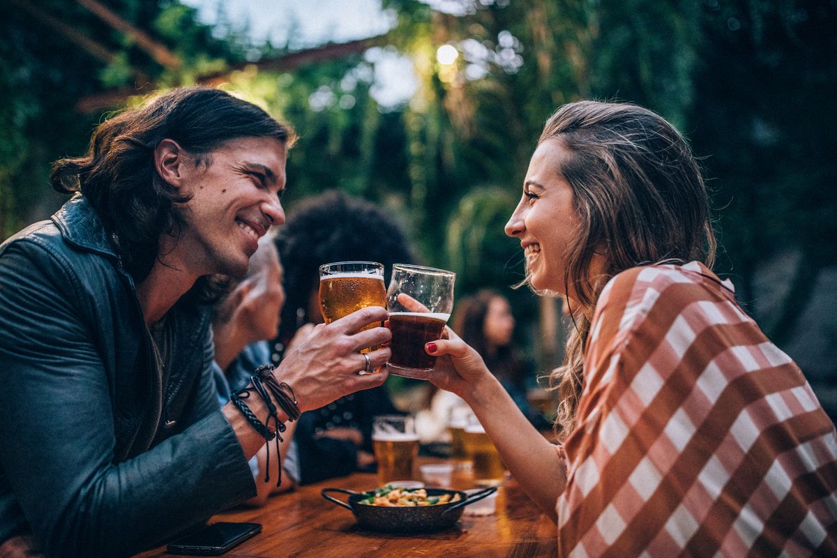 Man and woman drinking beer in pub
