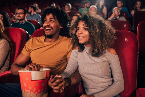 fun summer date ideas man and woman holding hands at cinema