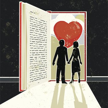 man and woman looking at a love story book