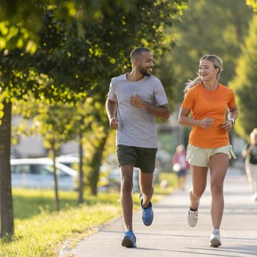 man and woman running in public park