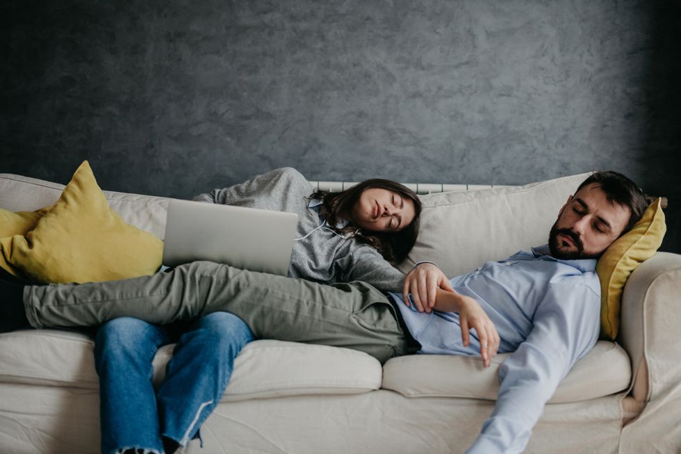 man and woman sleeping in a living room