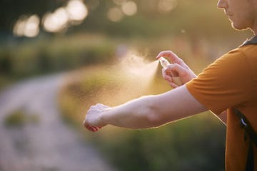 man applying insect repellent on his hand