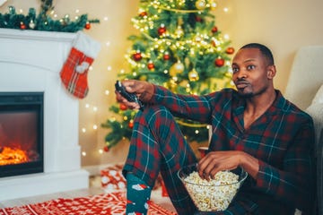 man at home during christmas is watching tv show