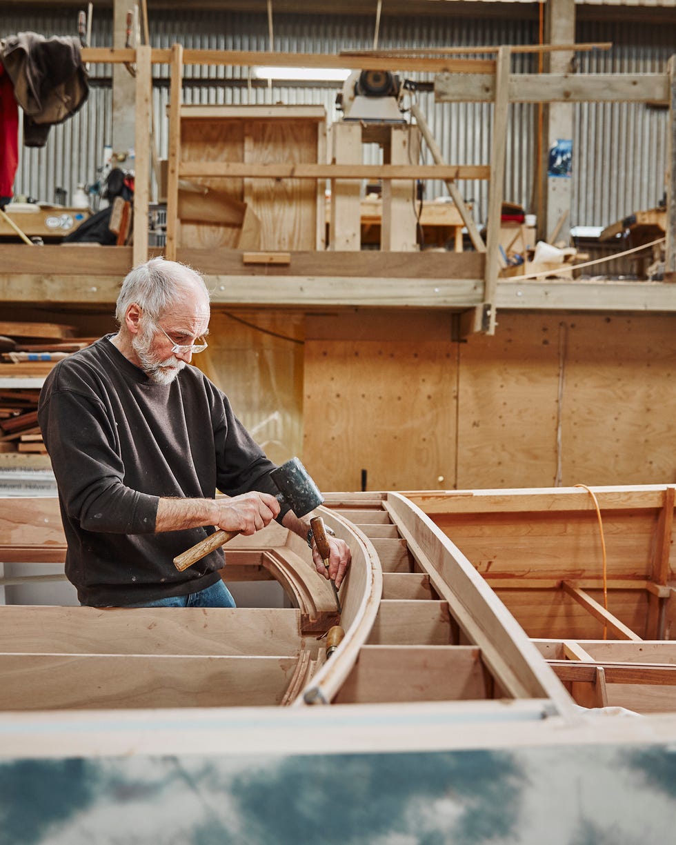 Man building a wooden boat