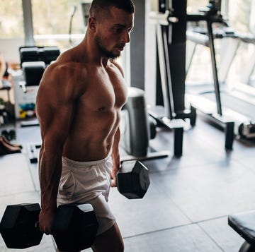 man carrying dumbbells