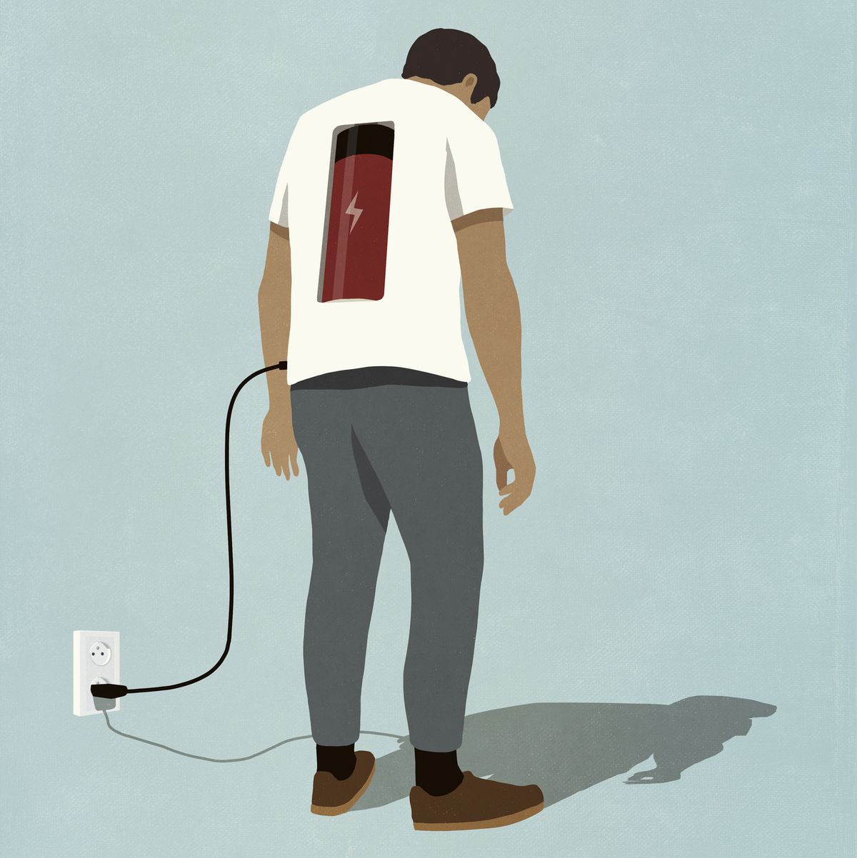 man charging battery in back with plug, standing at electric outlet