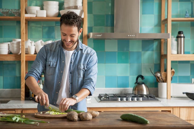 man chopping up fresh ingredients in kitchen
