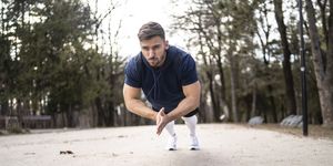 a man claps his hands together while doing push ups