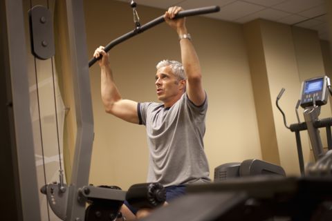 Man concentrates on his work out in a gym.
