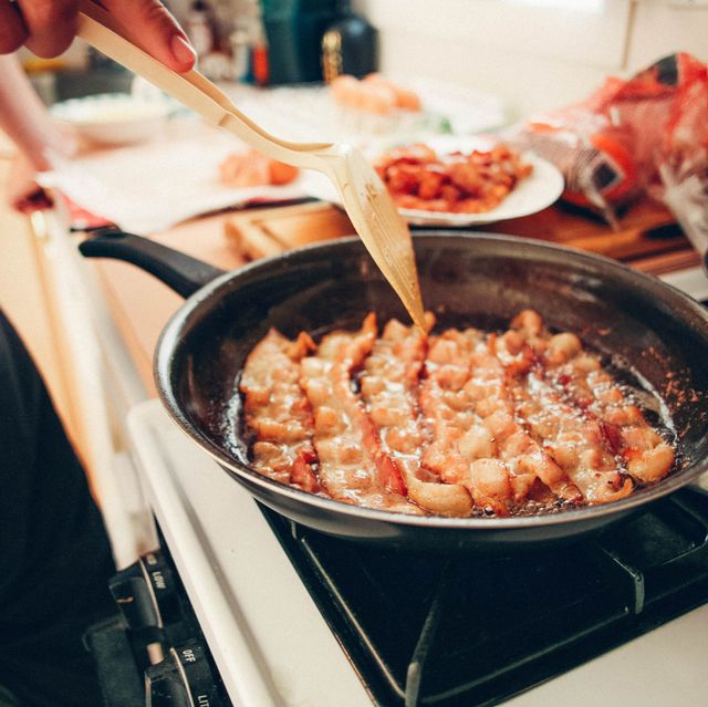 https://hips.hearstapps.com/hmg-prod/images/man-cooking-bacon-in-frying-pan-on-stove-greasy-royalty-free-image-1592391217.jpg?crop=0.668xw:1.00xh;0.167xw,0&resize=640:*