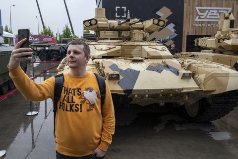 russian man takes selfie with bmpt terminator tank at army 2022 expo