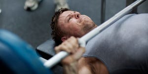 man doing benchpress in gym