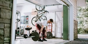 man doing exercise workout in garage, bone health for cyclists