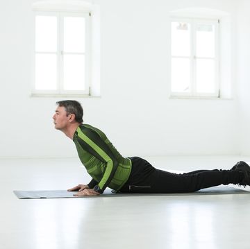 man doing his fitness regime, practising yoga poses
