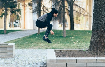 man doing jumping squats