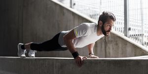 Man doing push-ups on concrete wall