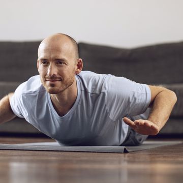 man doing yoga at home