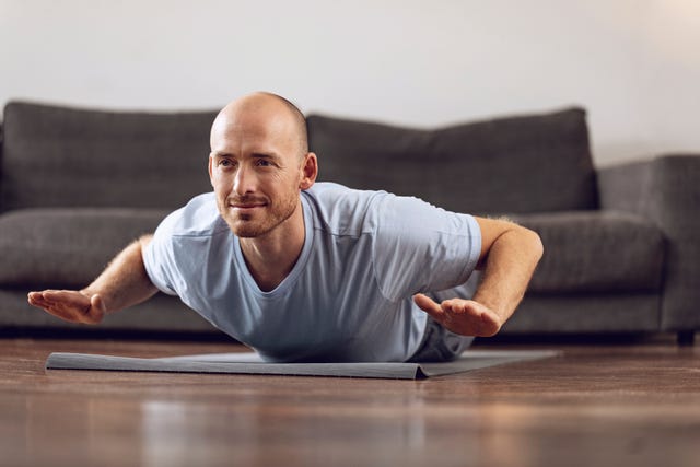 man doing yoga at home