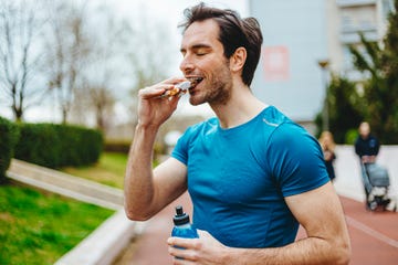 man eating energy bar