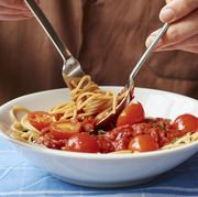 Man eating spaghetti with tomato sauce, close-up