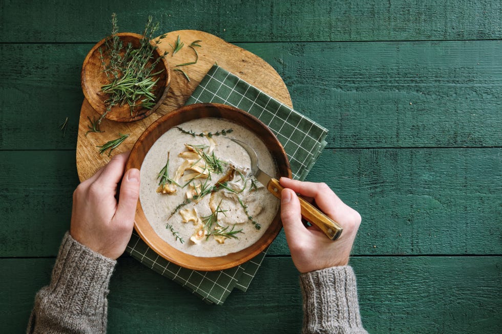 man eating vegan wild mushroom soup